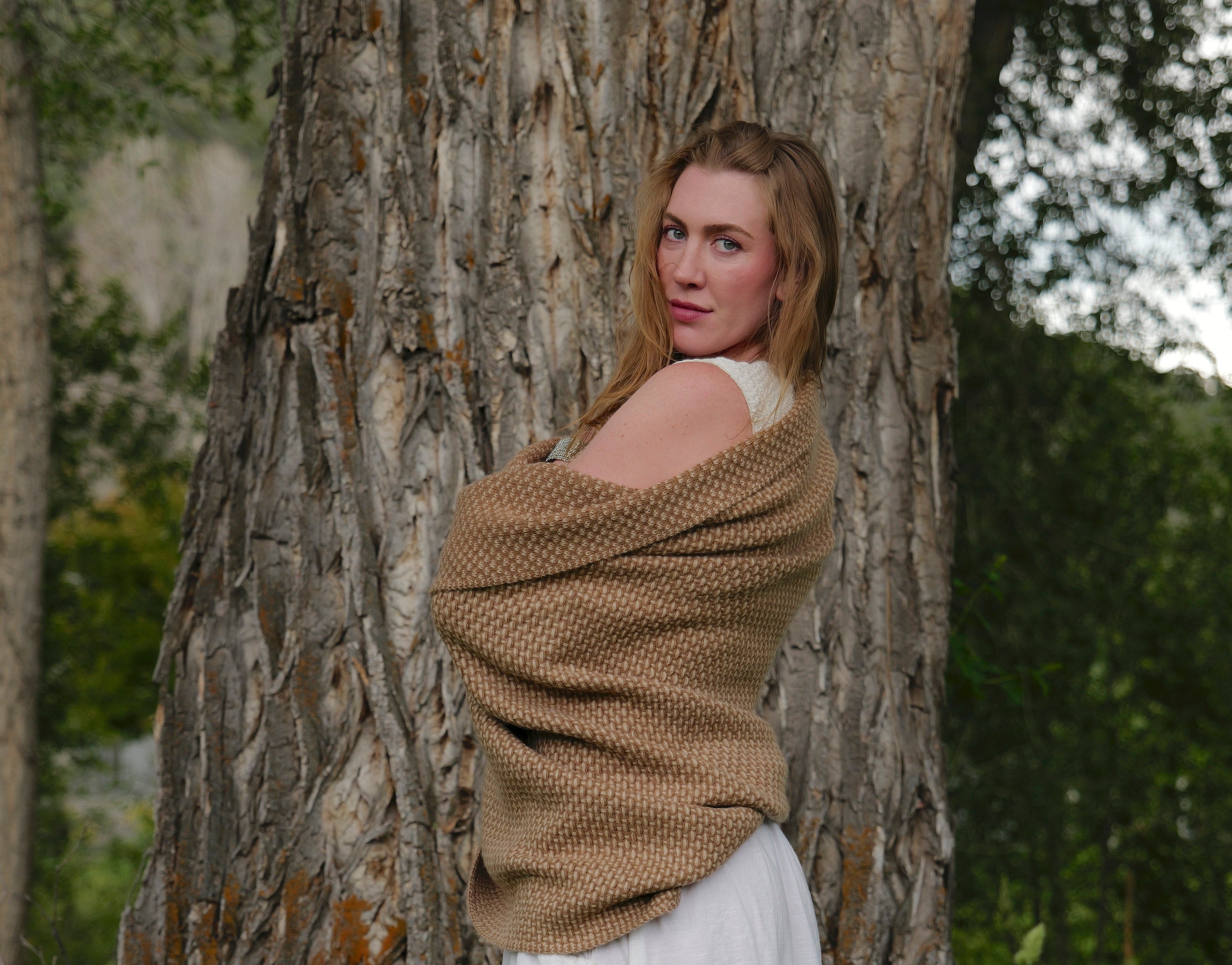 woman wrapped in a taiga camel throw